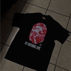 By bathing ape pink shirt.